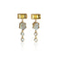 A pair of gold dangle earrings featuring rectangular yellow gemstones, oval moonstone charms, and small clear round stones, displayed on a clean white background with a soft reflection below.